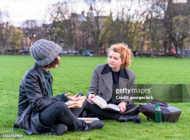 two students discussing their studies - winter woman showing stock pictures, royalty-free photos & images