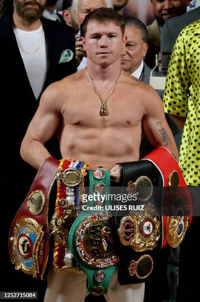 Mexican boxer Saul "Canelo" Alvarez poses with his belts before the weighing ceremony prior to his fight against British boxer John Ryder for the...