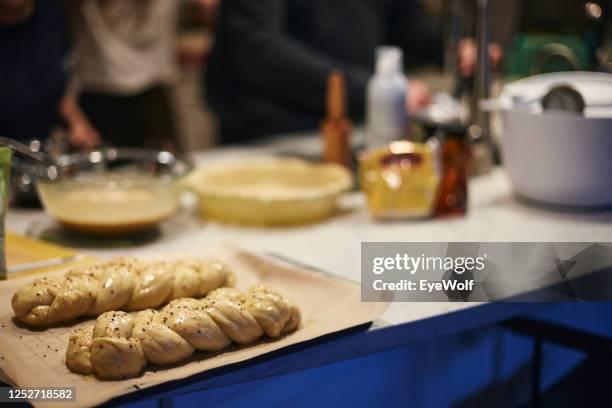 challah being baked during a passover seder. - passover seder stock-fotos und bilder