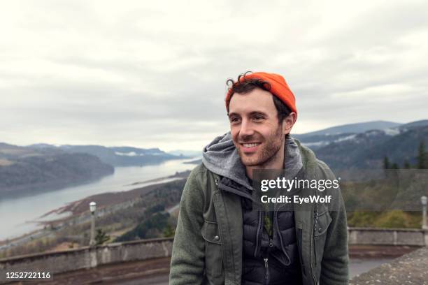 portrait of a man looking off camera, with a view of the columbia river gorge behind him. - portland oregon bildbanksfoton och bilder