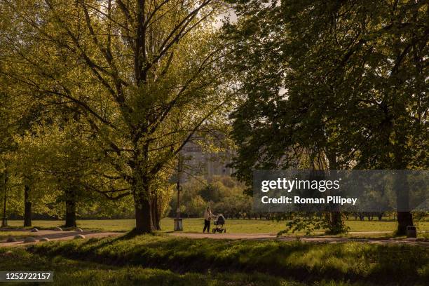 Woman walks with a baby carriage in a park at the Expocenter of Ukraine National Complex on May 5, 2023 in Kyiv, Ukraine. As the large-scale war with...