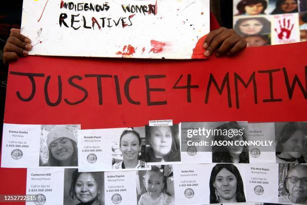 Student from the American Indian Academy of Denver displays a poster with the faces of missing or murdered indigenous persons during a student-led...