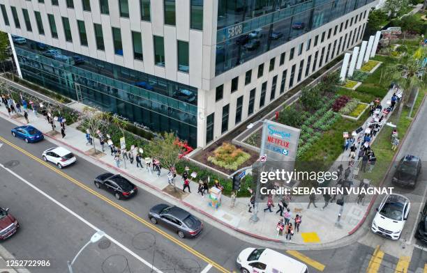This aerial view shows writers and their supporters walk the picket line outside the Netflix offices in Hollywood, California, on day four of the...