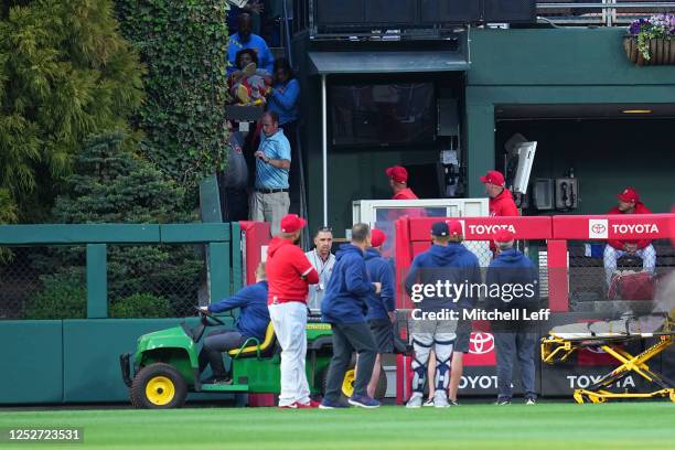 Medical staff tend to a fan who fell into the bullpen in the top of the first inning of the game during the game between the Boston Red Sox and...
