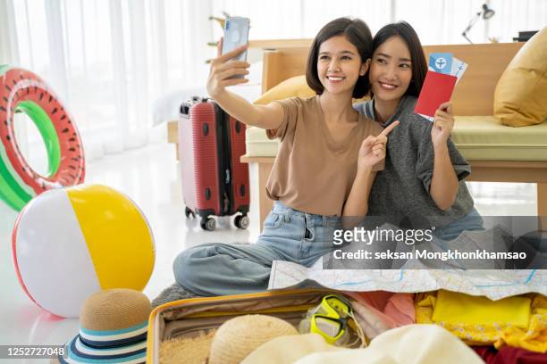 selfie with friends - asian girl doing online shopping ストックフォトと画像