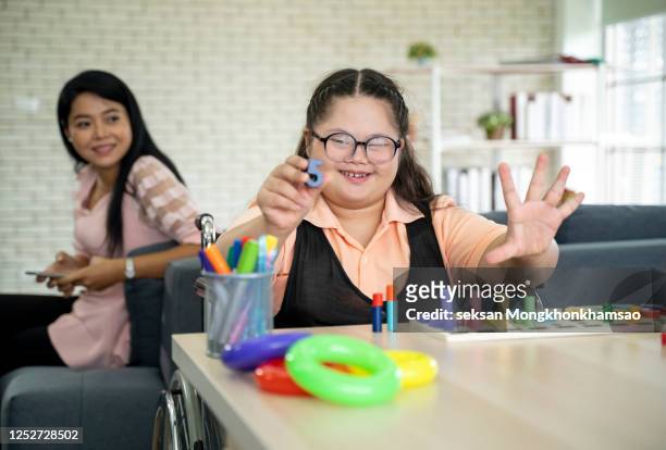 cheerful boy with disability at rehabilitation center for kids with special needs - handicapped adults stock-fotos und bilder