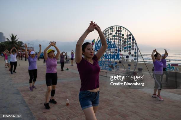 Women exercise at the My Khe beach in Da Nang, Vietnam, on Wednesday, May 3, 2023. Vietnam has eased access to funds and cut rates twice so far this...