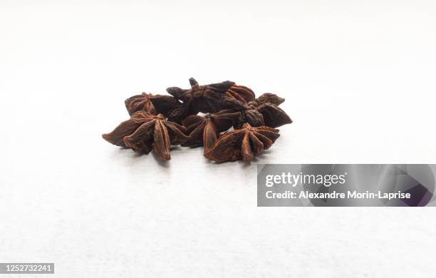 old star anise (illicium verum) on a white table in medellin, antioquia / colombia - ingredients isolated stock pictures, royalty-free photos & images