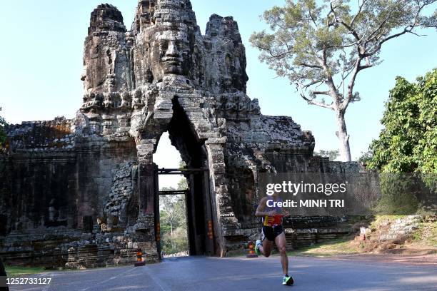 Arlan Estobo Arbois of the Phillipines competes in the men's marathon during the 32nd Southeast Asian Games at the Angkor Wat temple complex in Siem...