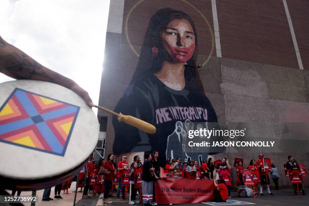 Participants gather at the Take Back the Power mural by artist Greg Deal during a rally supporting Missing or Murdered Indigenous Persons Awareness...