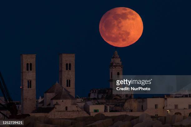 Full moon behind Molfetta Cathedral, also called the Full Moon of Flowers, on May 5 in Molfetta. The full moon in May is also called the Full Flower...
