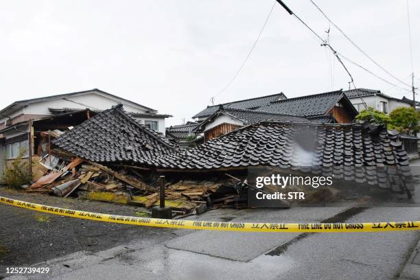 Building is pictured the day after it collapsed when a 6.5 magnitude earthquake hit the area, in the city of Suzu, Ishikawa prefecture on May 6,...
