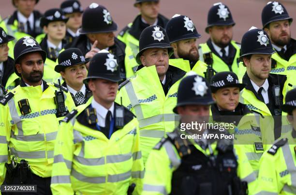 Metropolitan Police officers march along the procession route ahead of the Coronation of King Charles III and Queen Camilla on May 6, 2023 in London,...