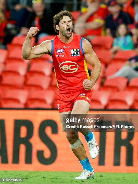 Levi Casboult of the Suns celebrates a goal during the 2023 AFL Round 08 match between the Gold Coast Suns and the Melbourne Demons at Heritage Bank...