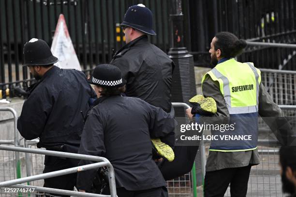 Protester from climate protest group 'Just Stop Oil' is arrested by police officers close to where Britain's King Charles III and Britain's Camilla,...