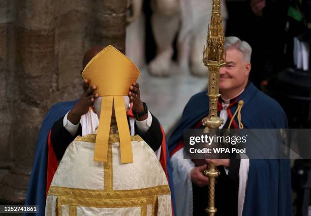 The mitre is placed on the head of the Archbishop of Canterbury Justin Welby ahead of the Coronation of King Charles III and Queen Camilla on May 6,...