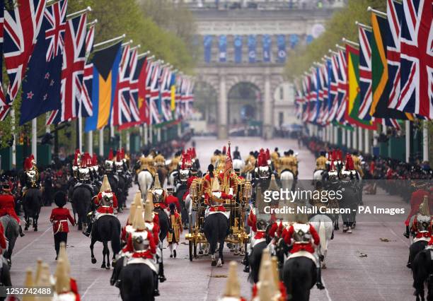 The Diamond Jubilee State Coach, accompanied by the Sovereign's Escort of the Household Cavalry, travels along The Mall in the King's Procession to...