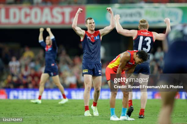 Melbourne players celebrate after the 2023 AFL Round 08 match between the Gold Coast Suns and the Melbourne Demons at Heritage Bank Stadium on May 6,...