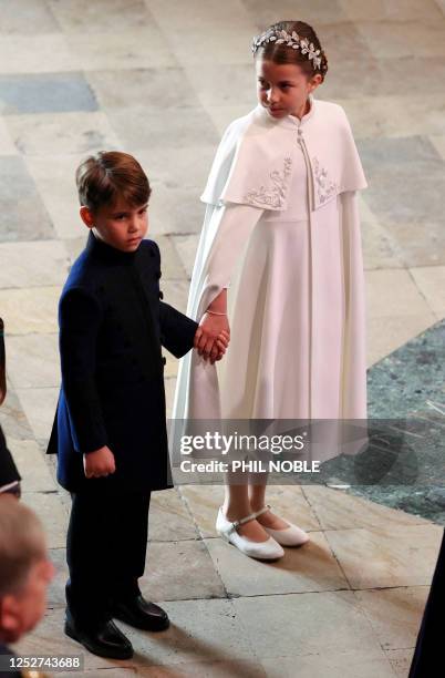 Britain's Princess Charlotte of Wales and Britain's Prince Louis of Wales arrive at Westminster Abbey in central London on May 6 ahead of the...