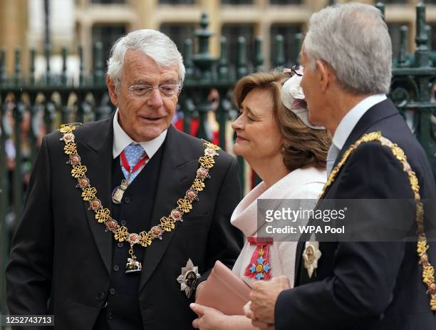 Former Prime Minister John Major with Cherie Blair and former Prime Minister Tony Blair arrive at the Coronation of King Charles III and Queen...