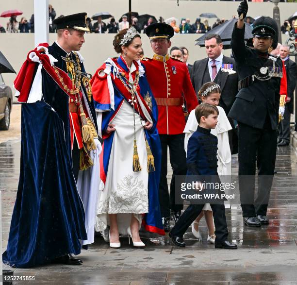 Prince William, Prince of Wales, Catherine, Princess of Wales, Prince Louis and Princess Charlotte arrive for the Coronation of King Charles III and...