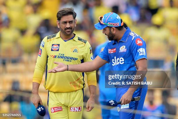 Mumbai Indians' Rohit Sharma gestures to Chennai Super Kings' Mahendra Singh Dhoni during the toss before the start of the Indian Premier League...