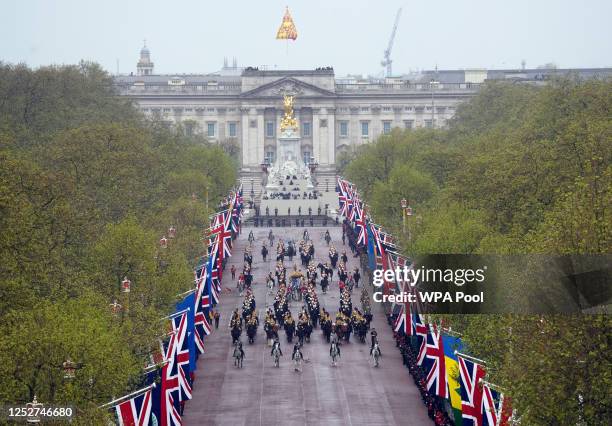 The Diamond Jubilee State Coach, accompanied by the Sovereign's Escort of the Household Cavalry, travels along The Mall en route to Westminster Abbey...