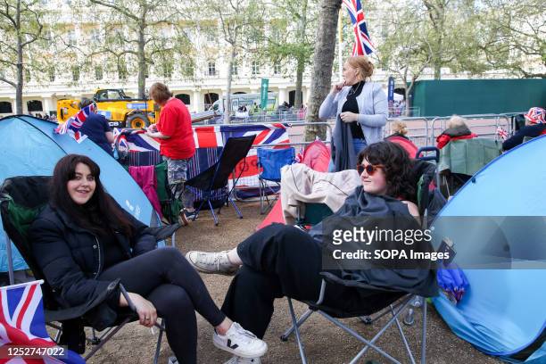 Royal supporters with their tents along the Mall in central London on the eve of the coronation of King Charles III. Thousands of people gathered to...