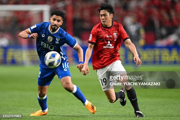 Urawa Reds' Ken Iwao and Hilal's Saleh al-Shehri fight for the ball during the second leg of the AFC Champions League final between Urawa Red...