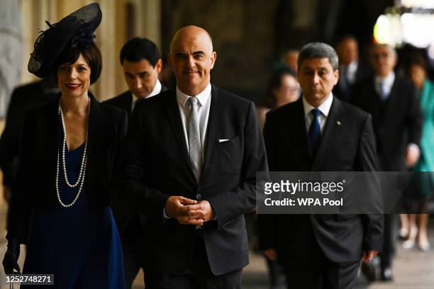 Swiss President Alain Berset and his wife Muriel Zeender Berset arrive to take their seats ahead of the Coronation of King Charles III and Queen...