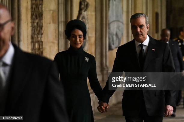 Dominican President Luis Abinader and his wife Raquel Arbaje arrive to take their seats inside Westminster Abbey in central London on May 6 ahead of...