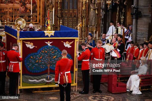 Queen Camilla watches as King Charles III is behind an anointing screen during their coronation ceremony in Westminster Abbey on May 6, 2023 in...