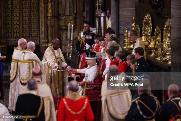 Queen Camilla is crowned by Archbishop of Canterbury Justin Welby during her coronation ceremony in Westminster Abbey, on May 6, 2023 in London,...
