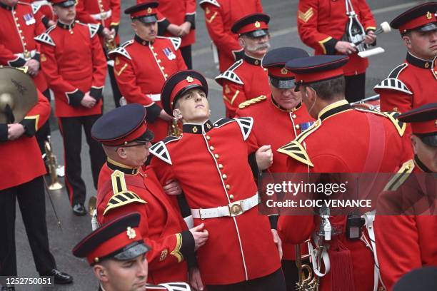 Bandsman is taken ill while taking part in the 'King's Procession', a journey of two kilometres from Buckingham Palace to Westminster Abbey in...