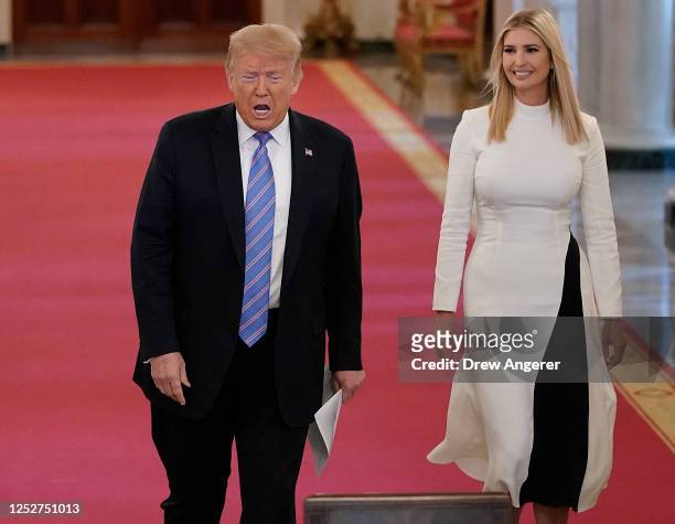 President Donald Trump and White House advisor Ivanka Trump arrive at a meeting of the American Workforce Policy Advisory Board in the East Room of...