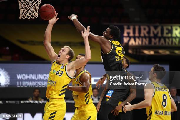 Luka Sikma of Berlin and Ariel Hukporti of Ludwigsburg jump for a rebound during the EasyCredit Basketball Bundesliga final first leg match between...