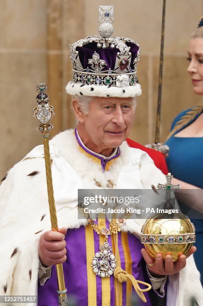 King Charles III, wearing the Imperial State Crown, leaves Westminster Abbey in central London following his coronation ceremony. Picture date:...
