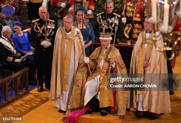 Britain's King Charles III with the St Edward's Crown on his head attends the Coronation Ceremony inside Westminster Abbey in central London on May...