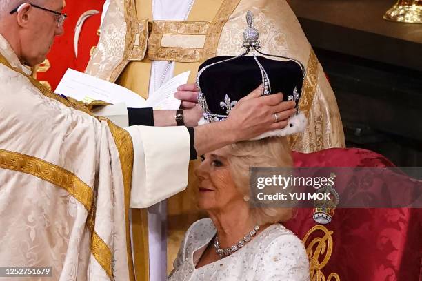 The Archbishop of Canterbury Justin Welby places a modified version of Queen Mary's Crown onto the head of Britain's Camilla, Queen Consort during...