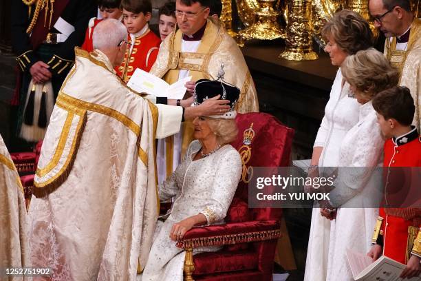 The Archbishop of Canterbury Justin Welby places a modified version of Queen Mary's Crown onto the head of Britain's Camilla, Queen Consort during...