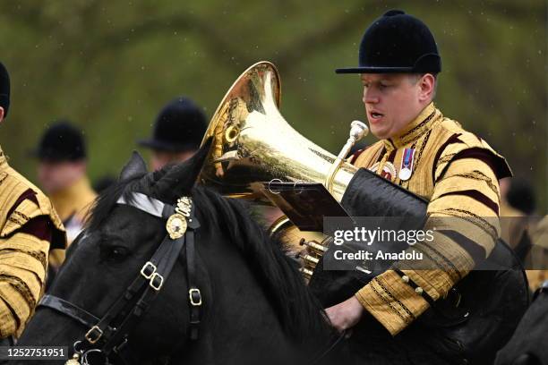 Mounted bands of the Household Cavalry, comprising the Life Guards and the Blues and Royals and led by two drum horses, crossing the parade at...