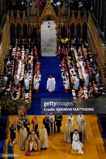 Britain's King Charles III wearing the Imperial state Crown, and Queen Camilla, wearing a modified version of Queen Mary's Crown attend the...