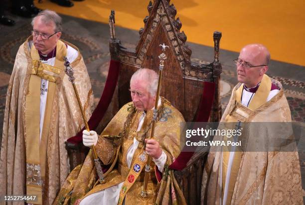 King Charles III holds the Sovereign's Sceptre with Cross and the the Sovereign's Sceptre with the Dove during his coronation ceremony in Westminster...