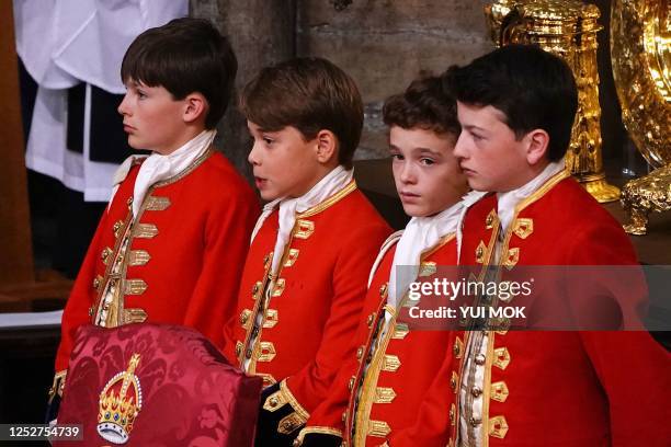 Prince George of Wales , with his fellow pageboys Ralph Tollemache , Oliver Cholmondley , and Nicholas Barclay stand at Westminster Abbey in central...