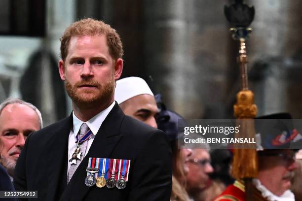 Britain's Prince Harry, Duke of Sussex looks on as Britain's King Charles III leaves Westminster Abbey after the Coronation Ceremonies in central...