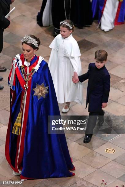 Princess Charlotte and Prince Louis hold hands following the Coronation of King Charles III and Queen Camilla at Westminster Abbey on May 6, 2023 in...