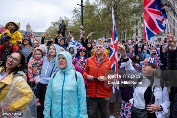 Crowds of people gather in the rain in central London to witness the Coronation of King Charles III on 6th May 2023 in London, United Kingdom....