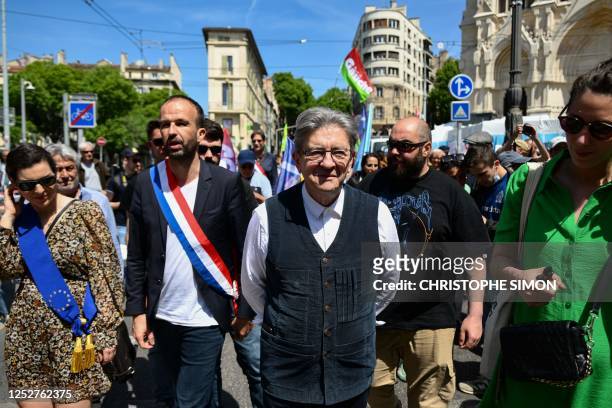 French leftist party La France Insoumise founder and member Jean-Luc Melenchon marches, flanked by French leftist La France Insoumise party Member of...