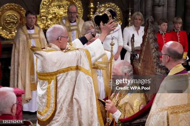 King Charles III is crowned with St Edward's Crown by The Archbishop of Canterbury the Most Reverend Justin Welby during his coronation ceremony in...