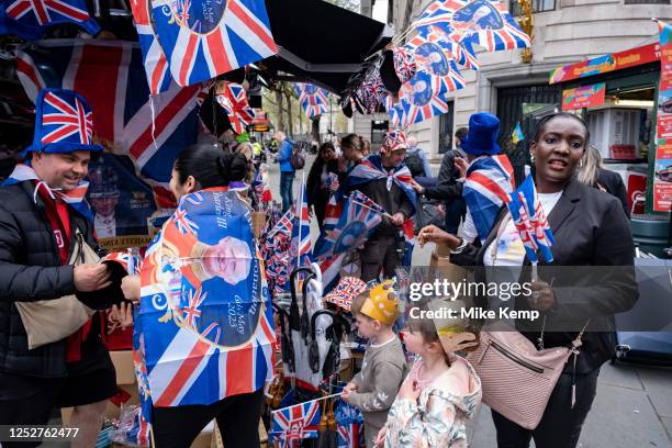 Souvenir sellers finally doing a good trade as crowds of people gather in central London to witness the Coronation of King Charles III on 6th May...
